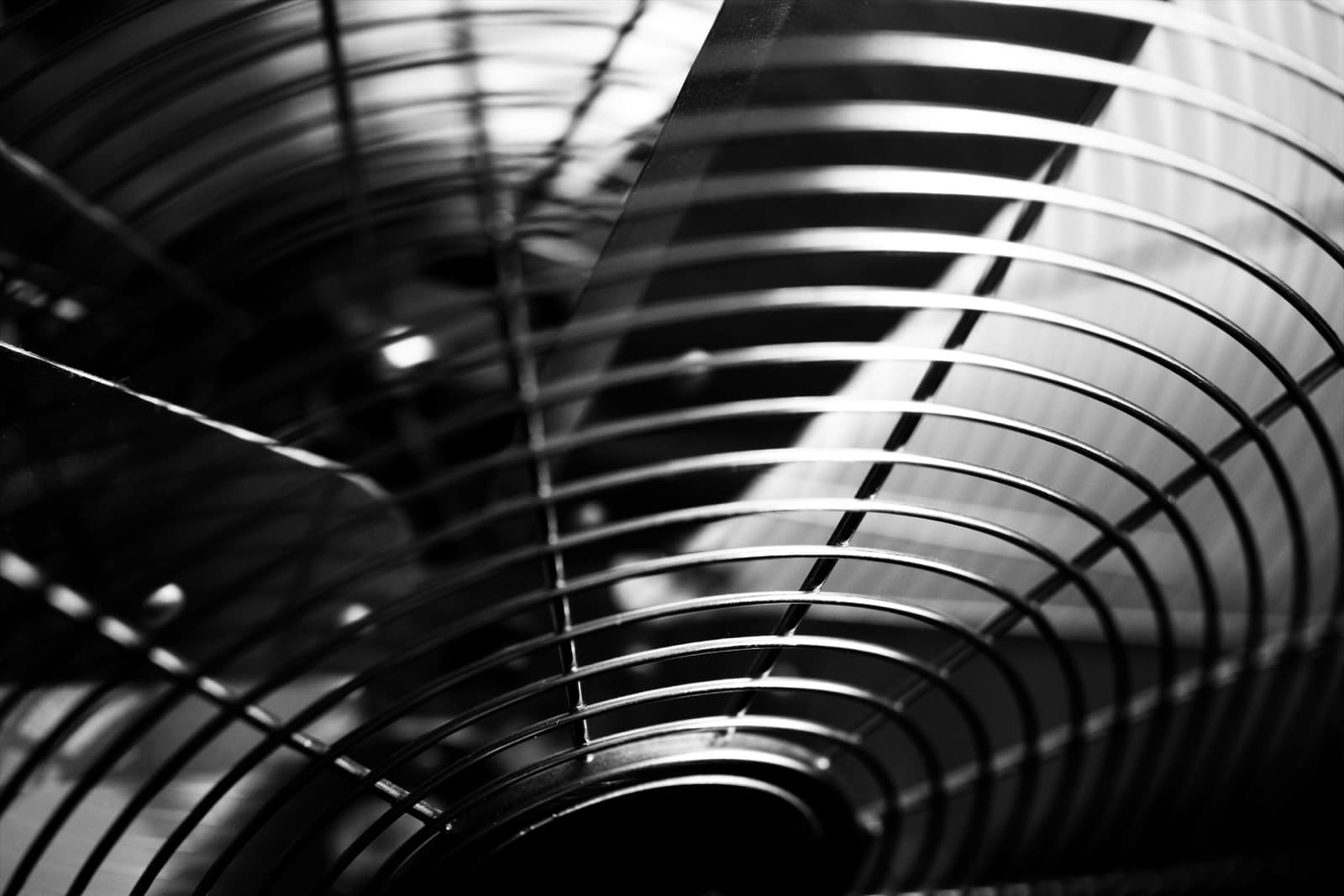 Close view of the fan and grille inside an air conditioning unit